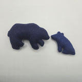 Two blue plush bears on a light gray background