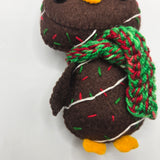 Chocolate Cake Penguin body with icing and sprinkles and red and green scarf on a white background