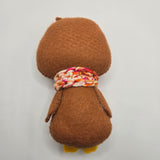 Brown plush gingerbread penguin back on a light gray background