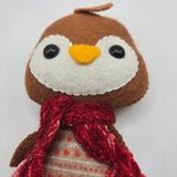 Gingerbread Penguin face with a red scarf on a white background