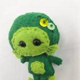Green plush Gillman with sequins on a white background
