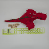 Handmade red felt dragon plush with white wings, small horns, and black button eyes. The soft stuffed dragon stands upright with a curved tail and stitched details.