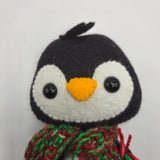 Felt penguin face on a white background