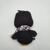 Penguin back with a multicolored scarf on a white background