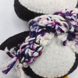 Close-up of a penguin body with a multicolored scarf on a white background