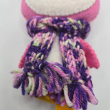Close-up of a pink penguin body with a multicolored purple scarf on a white background