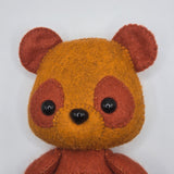 Small brown teddy bear plush toy face on a white background