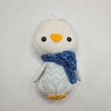 Small plush Winter-themed Penguin with a blue scarf and light blue and white stomach on a light gray background