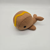 Handmade whale plush designed like a hot dog with mustard topping, soft brown food-themed whale stuffed animal on white background.